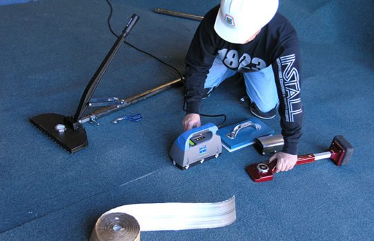 Floorcovering Mechanic Installing Carpet